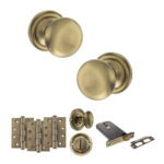 Atlantic Old English Harrogate Door Knob Pack (Lock Set - Horizontal Bathlock, 4" Fire Rated Hinges x3) - Antique Brass