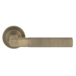 Eurospec Crown Knurled Lever on Sprung Screw-on Round Rose - Antique Brass